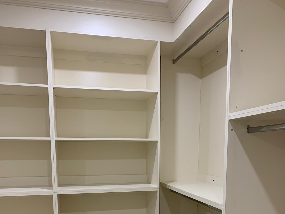 Closet interior with adjustable shelves and a hanging rail